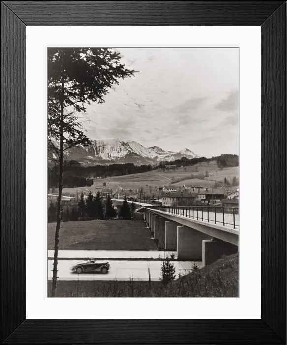 Framed Print : Automobile approaching overpass on the German Autobahn with countryside and mountains in the background. Ca. 1938. LC-USZ62-128819