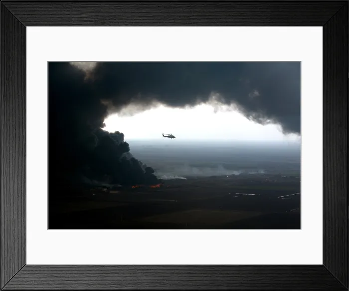 Framed Print : A plume of smoke surrounds a U.S. Army Black Hawk helicopter observing an oil pipeline fire outside Forward Operating Base McHenry Iraq on Dec. 27 2005. (BSLOC_2011_3_12)