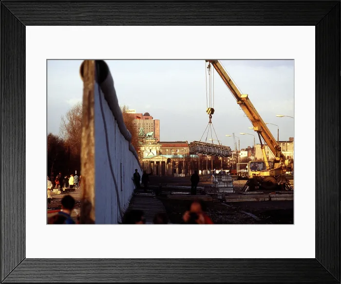 Framed Print : A newly created opening shows activities on both sides of the Berlin Wall near the Brandenburg Gate. Dec. 21 1989. (BSLOC_2011_3_53) Framed Print : A newly created opening shows activities on both sides of the Berlin Wall near the Brandenburg Gate. Dec. 21 1989. (BSLOC_2011_3_53)