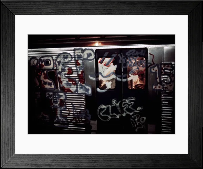Framed Print : New York City Subway. A subway car with aerosol sprayed paint over in windows and metal of its exterior