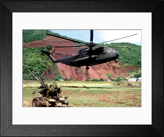 Framed Print : U.S. Marine Corps helicopter hovers near a Soviet anti-aircraft weapon during the U.S. invasion of Grenada in October 1983