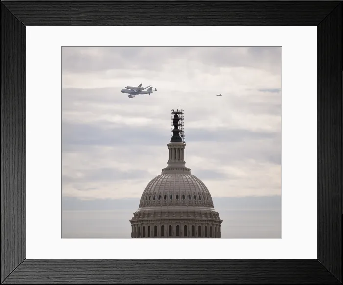 Framed Print : Retiring space shuttle Discovery atop a NASA 747, flies by the U.S. Capitol. Discovery's new home will be the National Air and Space Museum. April 17, 2012