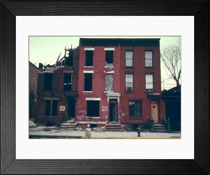 Framed Print : Substandard housing in Brooklyn New York City. People are still living in the building next to burnt ruins. June 1974