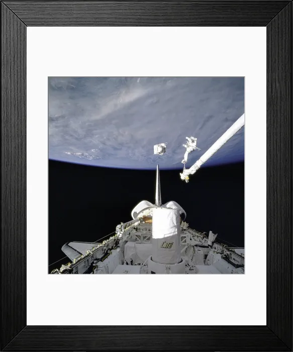 Framed Print : Astronaut demonstrate in-space rescue 130 miles from Earth. They tested a small, self-contained, propulsive backpack system for spacewalks. Sept. 16, 1994