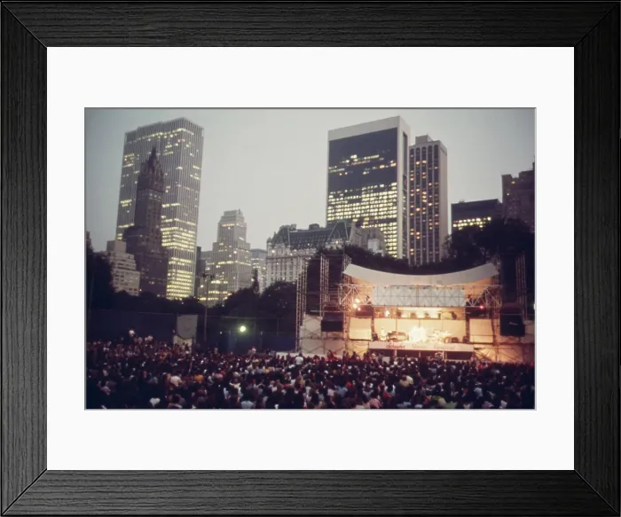 Framed Print : Concert in Central Park. The joys of urban live include events like the Judy Collins concert at the Schaefer Bandstand in Central Parks with its backdrop of midtown skyscrapers Framed Print : Concert in Central Park. The joys of urban live include events like the Judy Collins concert at the Schaefer Bandstand in Central Parks with its backdrop of midtown skyscrapers