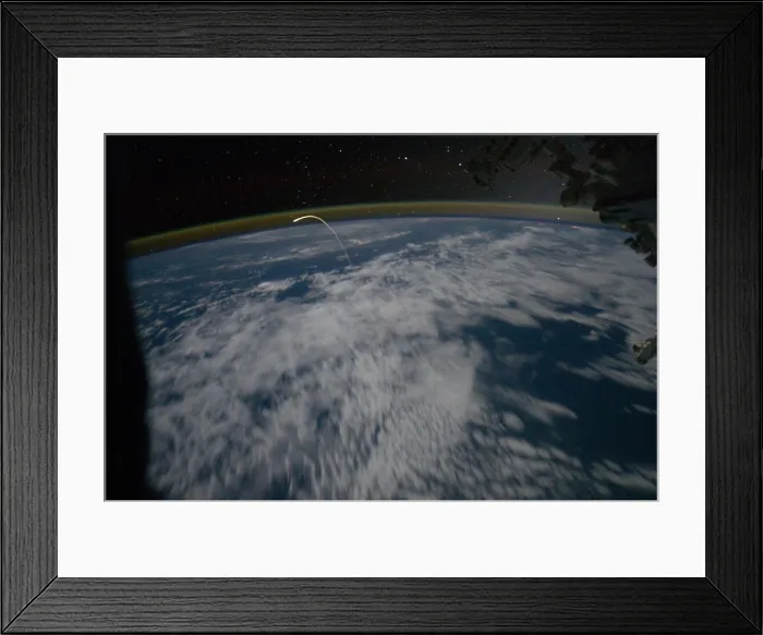 Framed Print : Space shuttle Atlantis re-entry flight path resembles a bean sprout against clouds and city lights. Photograph by the Expedition 28 crew in the International Space Station Framed Print : Space shuttle Atlantis re-entry flight path resembles a bean sprout against clouds and city lights. Photograph by the Expedition 28 crew in the International Space Station