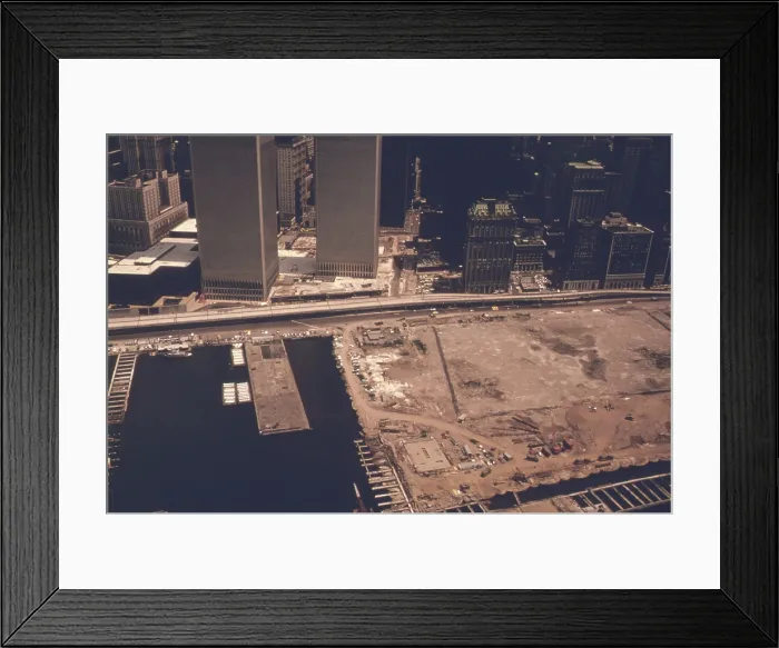 Framed Print : World Trade Center in downtown Manhattan is next to a growing landfill of refuse and ground excavated to build the Twin Towers complex Framed Print : World Trade Center in downtown Manhattan is next to a growing landfill of refuse and ground excavated to build the Twin Towers complex
