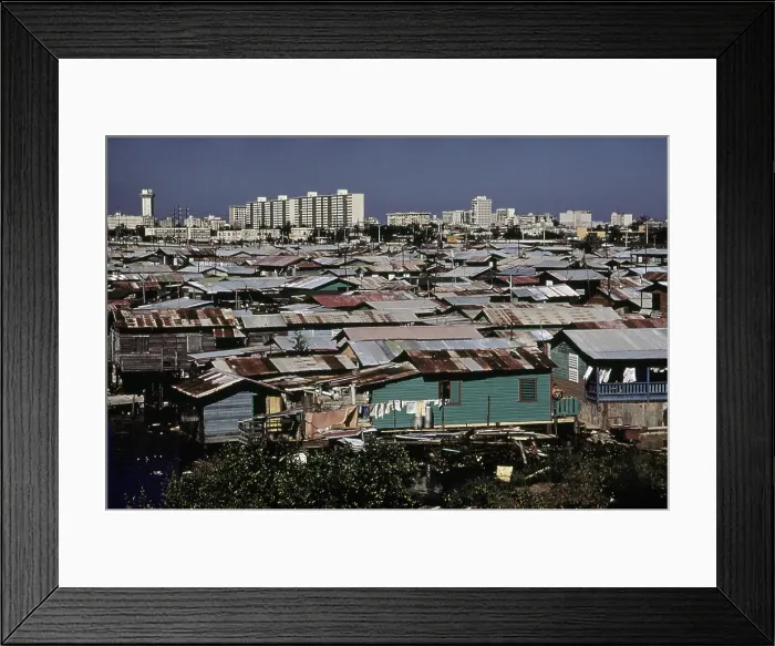 Framed Print : San Juan Puerto Rico. Modern buildings contrast with shanties along the Martin Pena Canal. Feb. 1973 Framed Print : San Juan Puerto Rico. Modern buildings contrast with shanties along the Martin Pena Canal. Feb. 1973