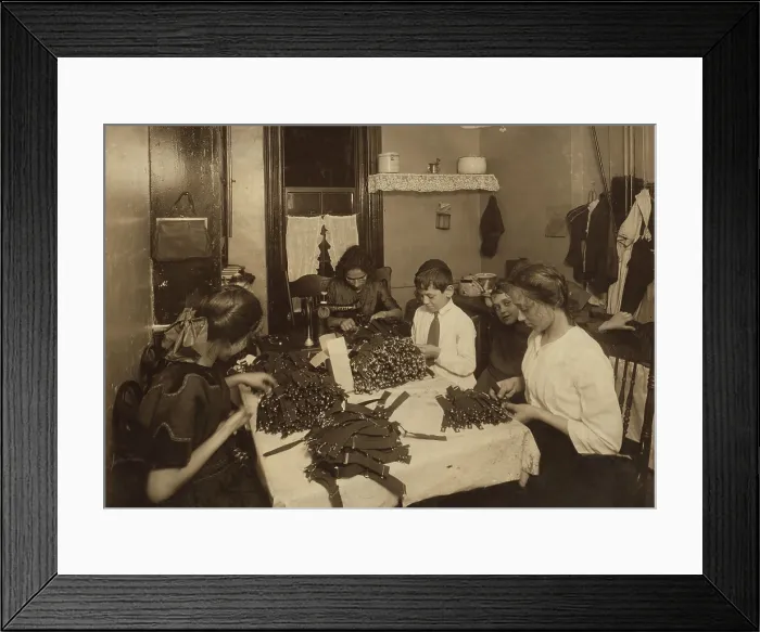 Framed Print : Jewish family working on garters in kitchen of a New York City tenement, Nov. 1912. The children are well dressed, indicating they attend school