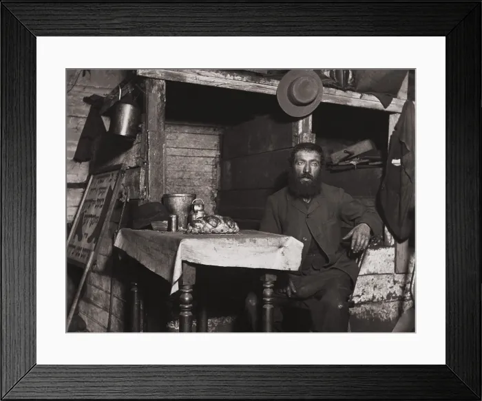 Framed Print : A cobbler in Ludlow Street sits down for Sabbath Eve in his coal celler lodging, c. 1889-90. Photo by Jacob Riis (BSLOC_2018_1_79) Framed Print : A cobbler in Ludlow Street sits down for Sabbath Eve in his coal celler lodging, c. 1889-90. Photo by Jacob Riis (BSLOC_2018_1_79)