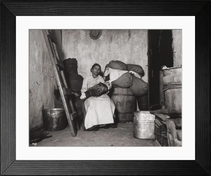 Framed Print : Italian immigrant rag-picker sits with her baby in a small run-down tenement room. Collecting salvage items to sell was work adopted by many poor urban immigrants Framed Print : Italian immigrant rag-picker sits with her baby in a small run-down tenement room. Collecting salvage items to sell was work adopted by many poor urban immigrants