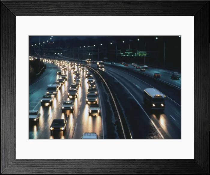 Framed Print : An express bus lane allows public transportation to speed past the congested rush hour traffic on the Shirley Highway connecting Washington DC with Virginia suburbs. Ca. 1973-75