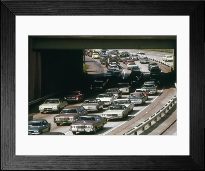 Framed Print : Heavy rush hour traffic as commuters drive to their suburban homes from their workplaces in Cleveland. Ca. 1973-75