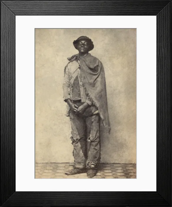 Framed Print : Civil War African American contraband wearing cleverly mended trousers, and a frayed blanket cape, c