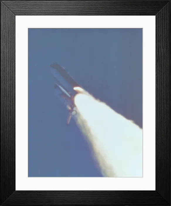 Framed Print : Space shuttle Challenger disaster. At 58.778 seconds into the flight, a large flame plume is visible on the booster rocket, indicating a breach in the motor casing. Jan. 28, 1986 Framed Print : Space shuttle Challenger disaster. At 58.778 seconds into the flight, a large flame plume is visible on the booster rocket, indicating a breach in the motor casing. Jan. 28, 1986