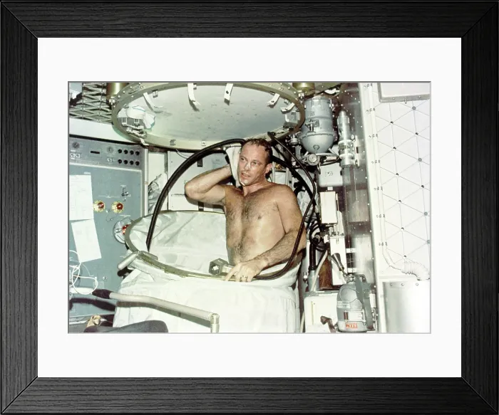 Framed Print : Astronaut Jack R. Lousma, taking a hot bath in the crew quarters aboard Skylab