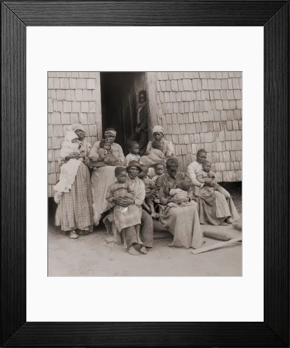 Framed Print : African American women, children, and one man seated outside a wood-shingled building, c. 1895 Framed Print : African American women, children, and one man seated outside a wood-shingled building, c. 1895