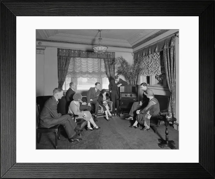 Framed Print : Group of men and women listening to a radio in the Hamilton Hotel, Washington, D.C. The Atwater Kent radio features an enclosed speaker at the top of the cabinet