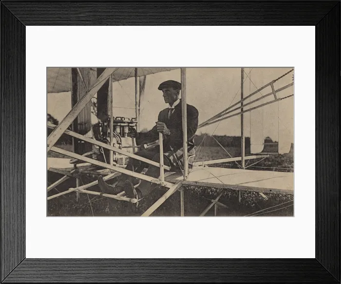 Framed Print : Wilbur Wright sits at the controls of his airplane, c. 1907-1908. He is in the Wright Model A, the first Wright aircraft in which the occupant sat upright (BSLOC_2018_2_148)