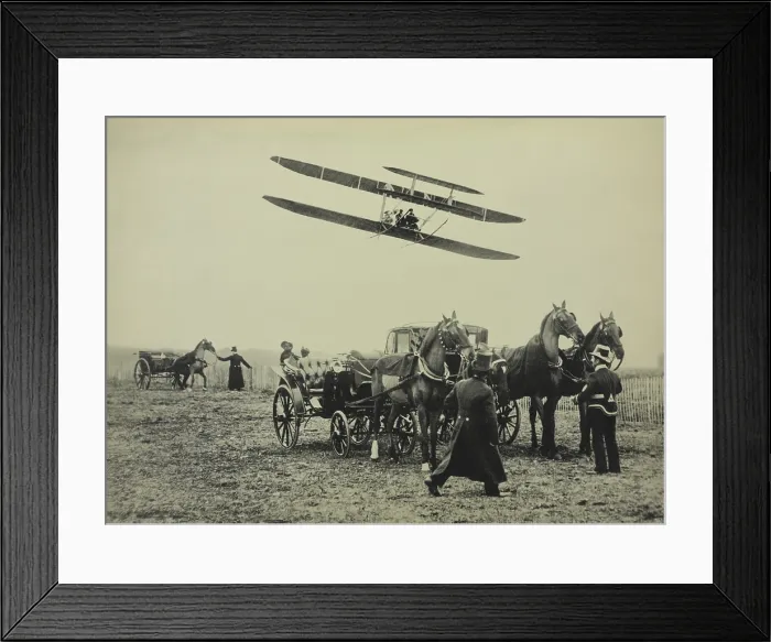 Framed Print : Flight of Wilbur Wright with his pupil Paul Tissandier, near Paris, January 1909. One the ground are coachmen and horse drawn carriages (BSLOC_2018_2_150)