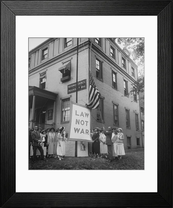 Framed Print : Raising the LAW NOT WAR banner over the HQ of the Council for Limitation of Armaments. July 23, 1923