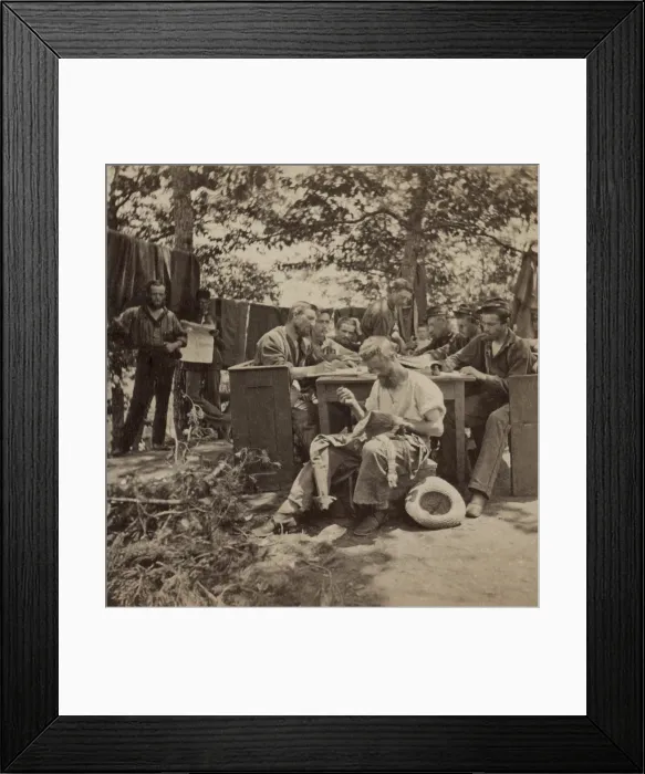 Framed Print : US Civil War, June 1861. Boston Light Artillery soldiers in camp at Relay House, Maryland, sit at a long table, writing letters. One soldier, in the foreground is sewing