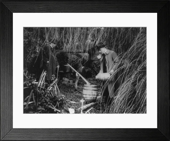 Framed Print : Prohibition law enforcers dismantling a still in San Francisco, c. 1920s. The still had three simple parts to distill alcohol from fermented liquids