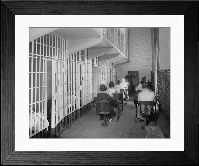 Framed Print : Young women at desks in an American jail c. 1920. Dressed in street clothing, they sit in two rows of desks in a cellblock Framed Print : Young women at desks in an American jail c. 1920. Dressed in street clothing, they sit in two rows of desks in a cellblock