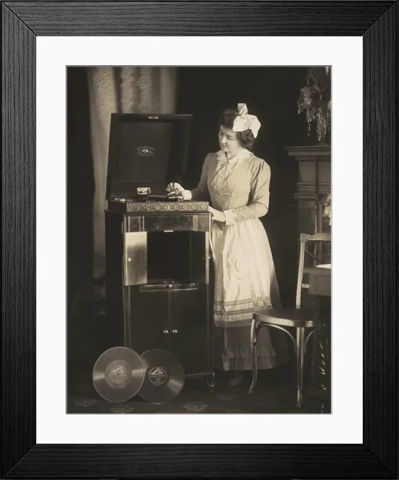 Framed Print : Woman beginning to play a phonograph in 1908