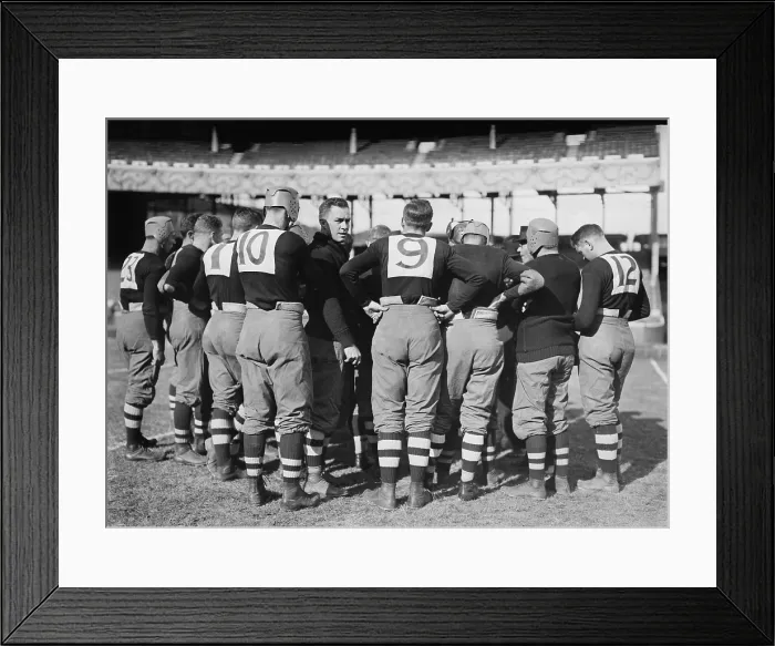 Framed Print : Brown University football team in a huddle at the Polo Grounds, during a game against Cornell Framed Print : Brown University football team in a huddle at the Polo Grounds, during a game against Cornell