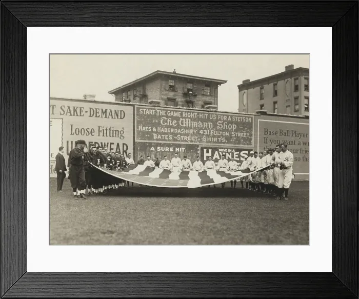 Framed Print : Buffalo Bisons and Brooklyn Tip Tops baseball players holding a large American flag, 1914