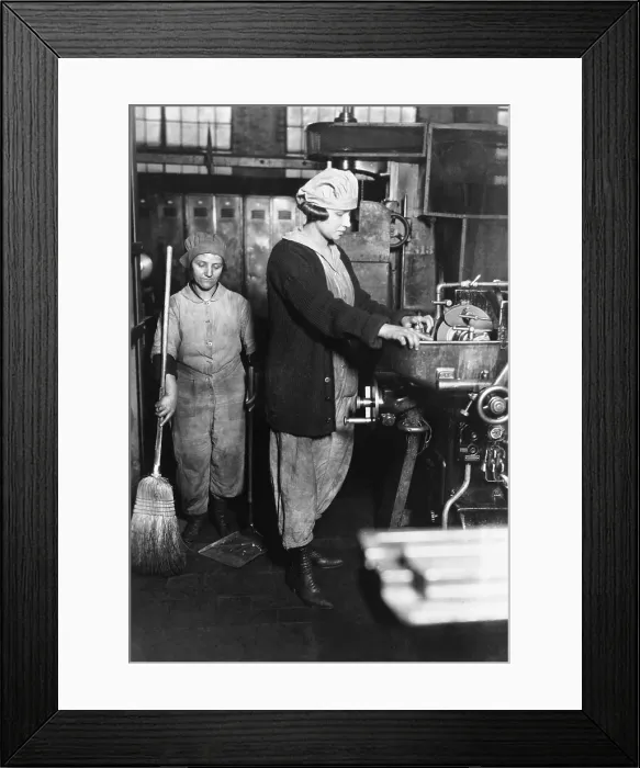 Framed Print : Woman grinding small gear cutter at Midvale Steel & Ordnance Company, Nicetown, Pennsylvania. Beside her is another female war worker with a broom and dustpan