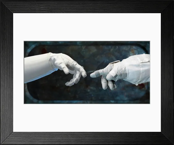 Framed Print : Robonaut hand (left), and a spacesuit-gloved human-hand. Called the Human Grasp Assist Device, it is the first humanoid robot in space