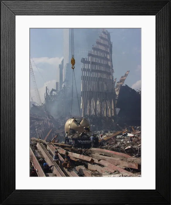Framed Print : Cables are placed around THE SPHERE sculpture by German sculptor Fritz Koenig before it is hoisted out of the rubble, September 21, 2001. Photo: Everett Collection