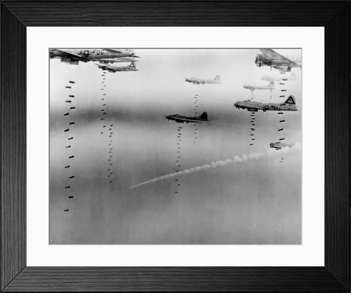 Framed Print : B-17 Flying Fortresses of U.S. 8th Air Force bombing Dresden in April 17, 1945. A disabled plane leaves a smoke trail as it descends in the background