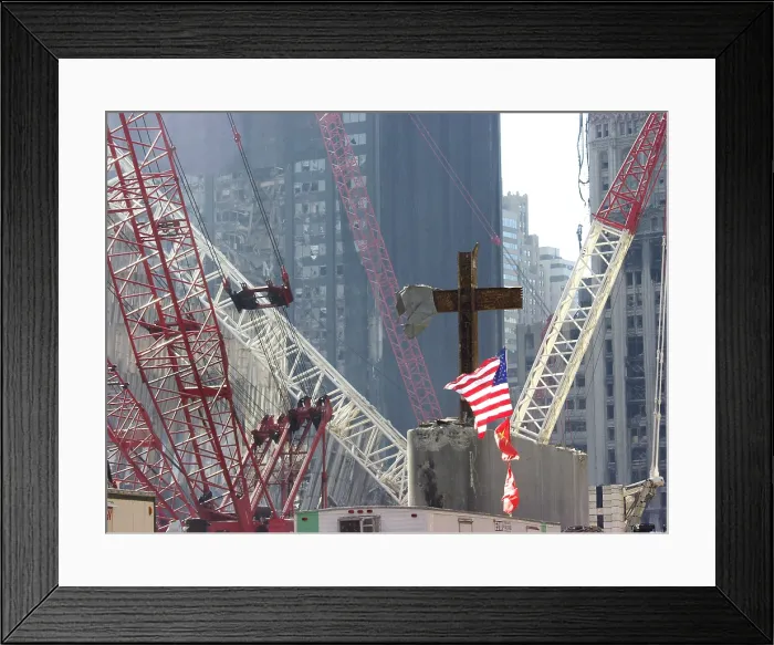 Framed Print : At the World Trade Center disaster site workers use heavy machinery to remove one of the steel beams from the section dubbed God's House in reference to the many