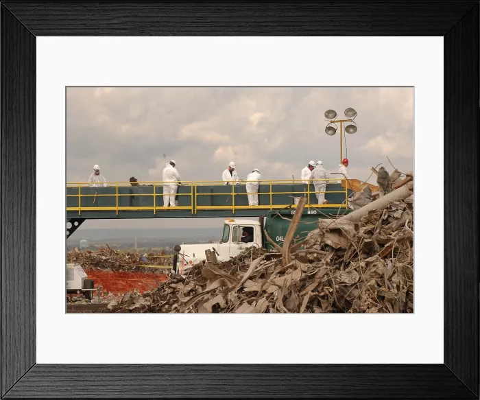Framed Print : Workers at the Fresh Kills Landfill examine debris from the World Trade Center for victim identification and evidence related to the attack. Oct. 16 2001 Framed Print : Workers at the Fresh Kills Landfill examine debris from the World Trade Center for victim identification and evidence related to the attack. Oct. 16 2001