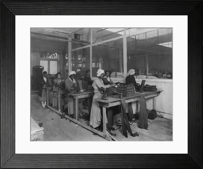 Framed Print : African American women workers manufacturing puttees in New York City, Nov. 4, 1918. On the other side of the windows, are women in a segregated White section of the factory Framed Print : African American women workers manufacturing puttees in New York City, Nov. 4, 1918. On the other side of the windows, are women in a segregated White section of the factory