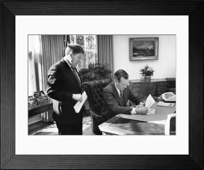 Framed Print : President George H.W. Bush, at his desk in the Oval Office, speaks to his Chief of Staff, John Sununu, on his first full day in office, Jan. 21, 1989 (BSLOC_2021_3_47)