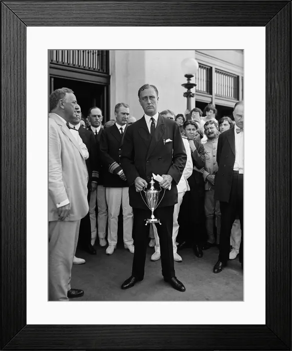 Framed Print : Assist. Navy Sec. Franklin D. Roosevelt standing awkwardly for news photographers with a trophy. At left is his boss, Sec. of the Navy, Josephus Daniels, c