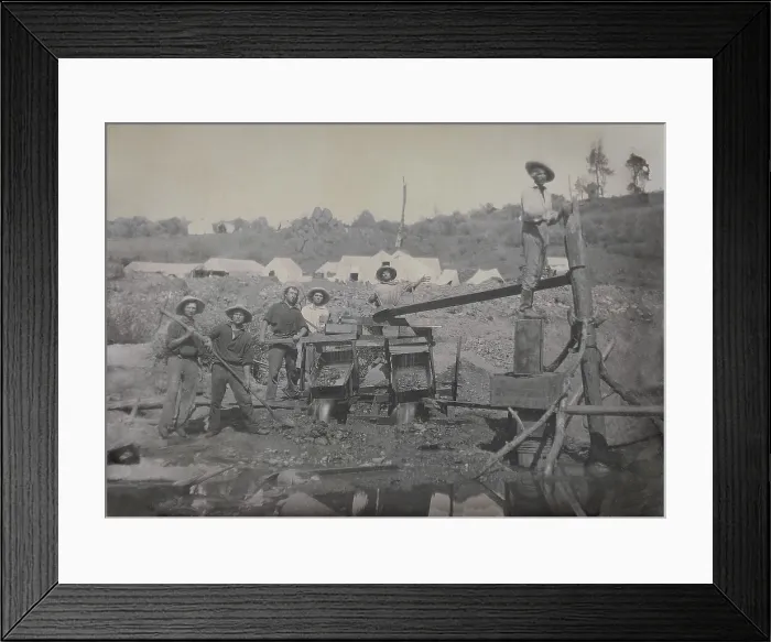 Framed Print : Six miners work with a placer mining apparatus in California in the 1850s. In the background are several tents, likely the miners temporary tent community