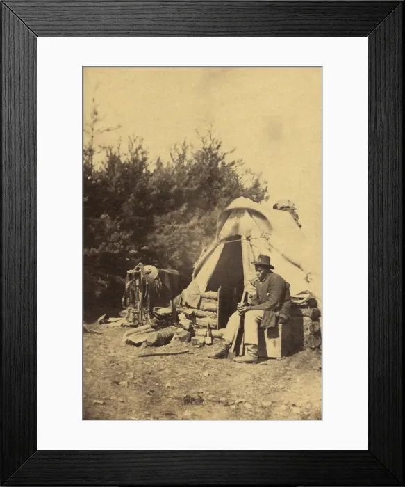 Framed Print : African American man, sitting outside a military camp tent holding an ax, during the Civil War, 1861-65. It is unclear whether he is contraband or a soldier Framed Print : African American man, sitting outside a military camp tent holding an ax, during the Civil War, 1861-65. It is unclear whether he is contraband or a soldier