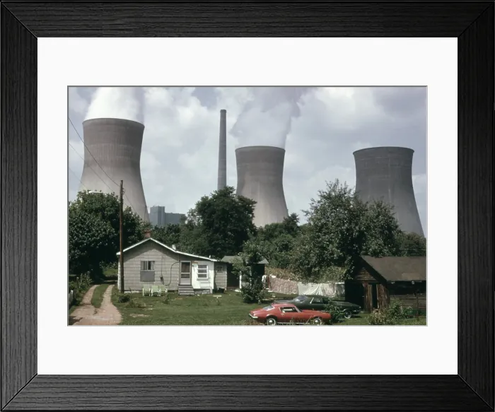 Framed Print : Water cooling towers of the John Amos Power Plant loom over a West Virginia home across the Kanawha River. The coal powered plant was named after a state politician Framed Print : Water cooling towers of the John Amos Power Plant loom over a West Virginia home across the Kanawha River. The coal powered plant was named after a state politician