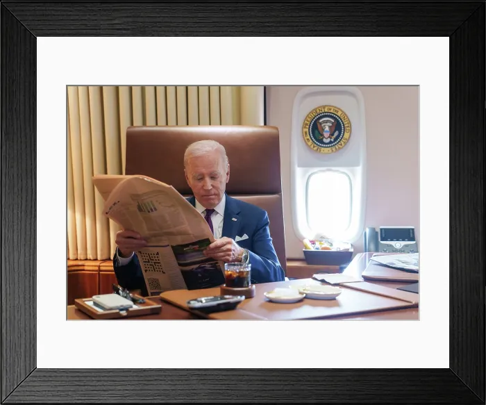 Framed Print : President Joe Biden reads a newspaper aboard Air Force One, June 29, 2023, en route to JFK Airport, New York City. (BSLOC_2023_8_4) Framed Print : President Joe Biden reads a newspaper aboard Air Force One, June 29, 2023, en route to JFK Airport, New York City. (BSLOC_2023_8_4)