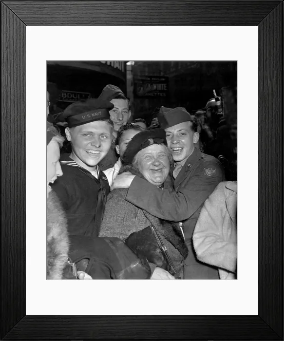 Framed Print : V-E Day celebration in Piccadilly Circus, London, May 7, 1945. A jubilant American soldier hugs a motherly English woman celebrating Germany's unconditional surrender