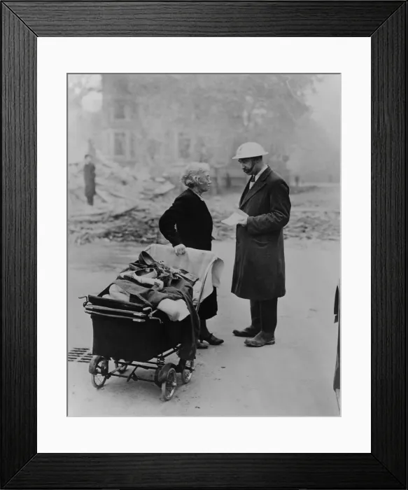 Framed Print : A bombed out London women carrying a few belongings talks with an Air Raids Precautions worker. 1940 during the Battle of Britain in World War 2. (BSLOC_2013_14_17) Framed Print : A bombed out London women carrying a few belongings talks with an Air Raids Precautions worker. 1940 during the Battle of Britain in World War 2. (BSLOC_2013_14_17)