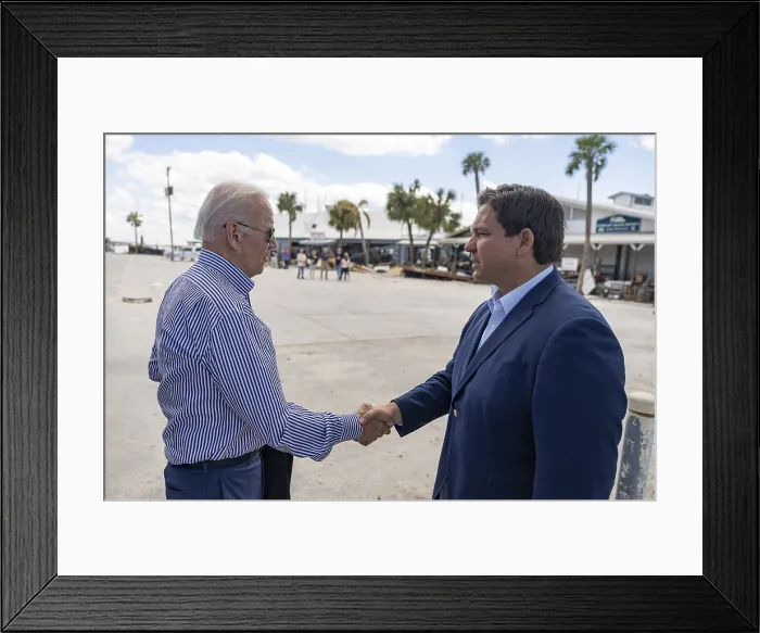 Framed Print : Florida Gov. Ron DeSantis greets President Joe Biden as he and First Lady Jill Biden arrive at Fisherman's Wharf in Fort Myers, Oct. 5, 2022