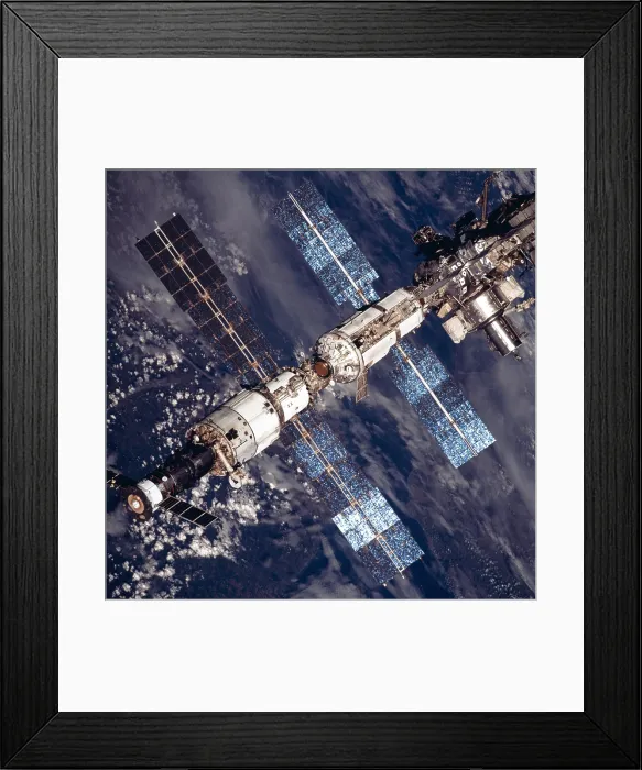 Framed Print : International Space Station in 2001. Overhead close-up view of the expanded International Space Station. At lower left a Russian Soyuz capsule is docked