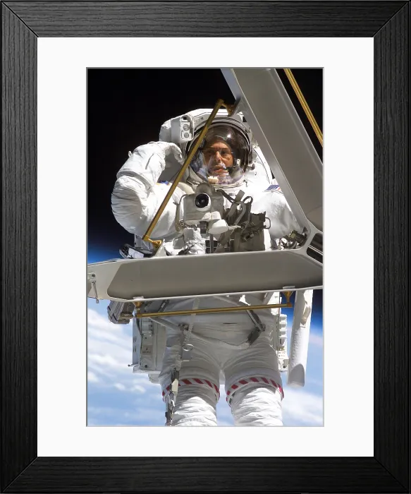 Framed Print : Construction work on International Space Station. Astronaut Lee Morin, totes a large, but weightless, metal piece just removed from the space station exterior Framed Print : Construction work on International Space Station. Astronaut Lee Morin, totes a large, but weightless, metal piece just removed from the space station exterior