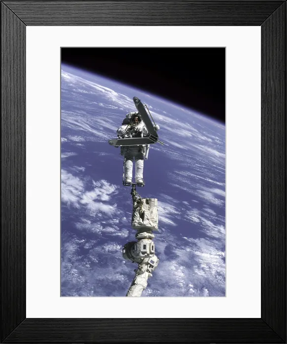 Framed Print : Construction work on International Space Station. Astronaut Lee Morin totes a large, but weightless, metal piece just removed from the space station exterior Framed Print : Construction work on International Space Station. Astronaut Lee Morin totes a large, but weightless, metal piece just removed from the space station exterior